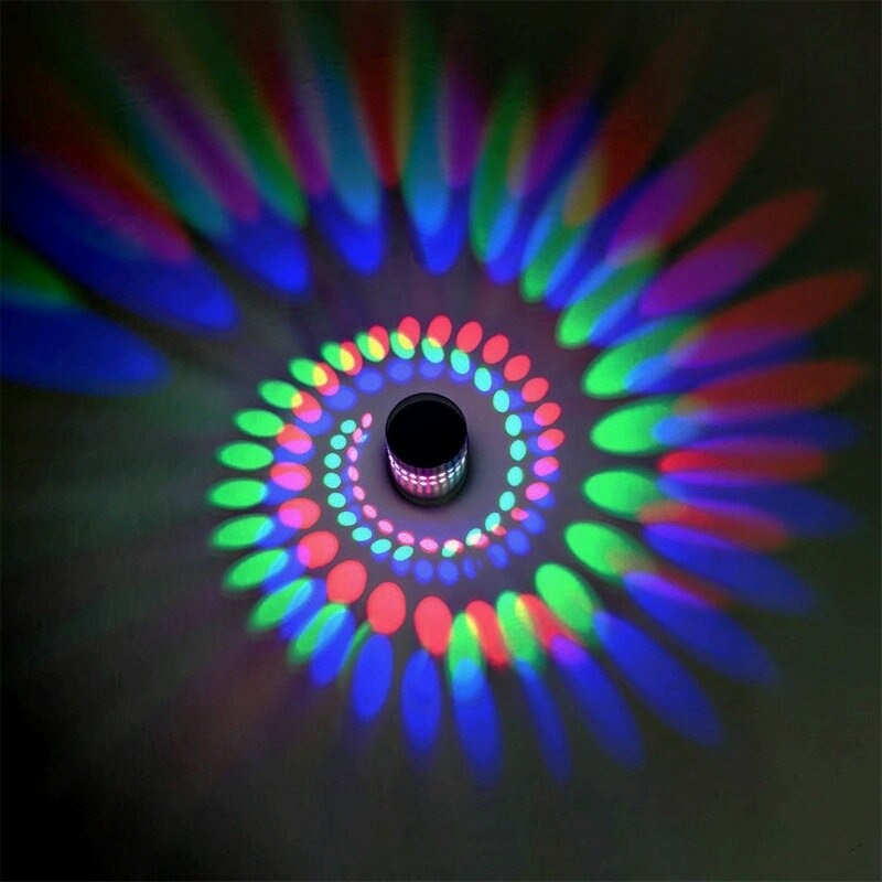 Spiral LED light casts vivid red, green, blue dots for dramatic, dynamic accent lighting.