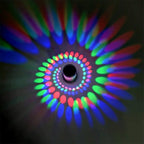 Vivid red, green, and blue LED patterns create hypnotic, eye-catching illumination on dark walls.