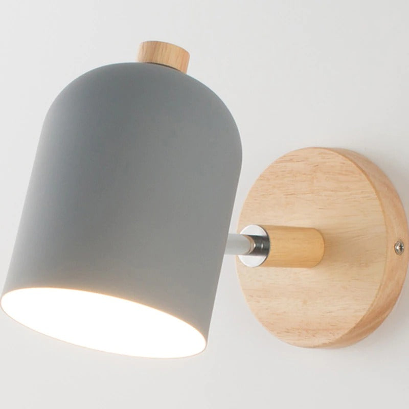 Soft white glow streams from a matte gray shade, creating gentle, modern wall illumination.