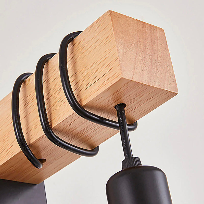 Mounting the sconce: black cable and bracket ensure sleek, modern lighting installation.
