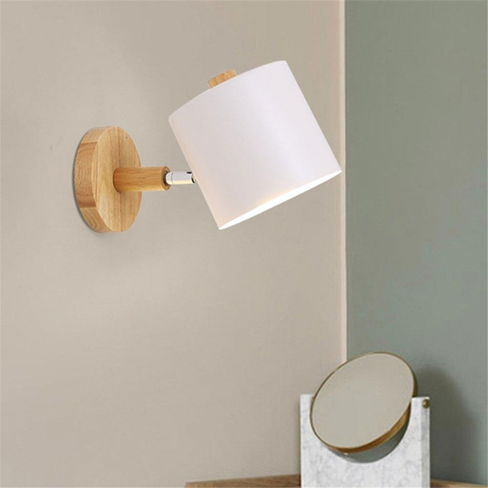 The wooden wall lamp's adjustable metal shade offers stylish, targeted Scandinavian-inspired lighting.
