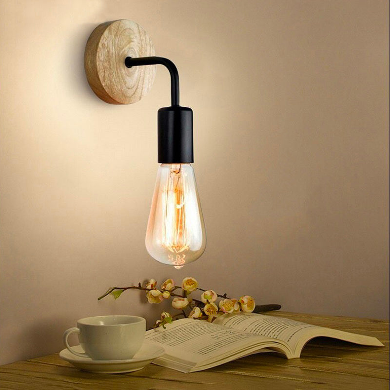 The exposed bulb of the ORLUNE HOME wall light brightens bedrooms with warm industrial glow.