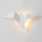 This origami-inspired LED wall light emits a warm, gentle yellow glow for ambiance.