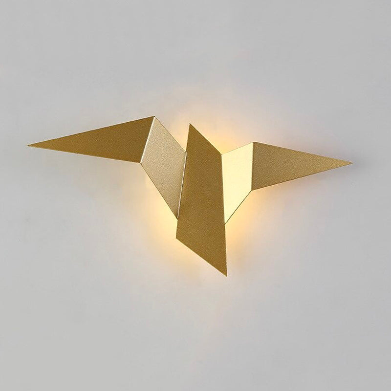 Warm LED glow radiates behind a gold bird light, casting elegant ambient illumination.