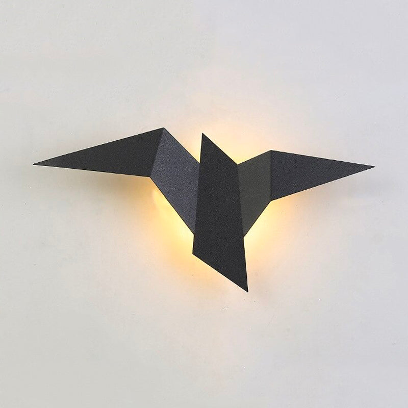 Bird-shaped metal LED wall light casts a cozy, modern glow with origami-like panels.