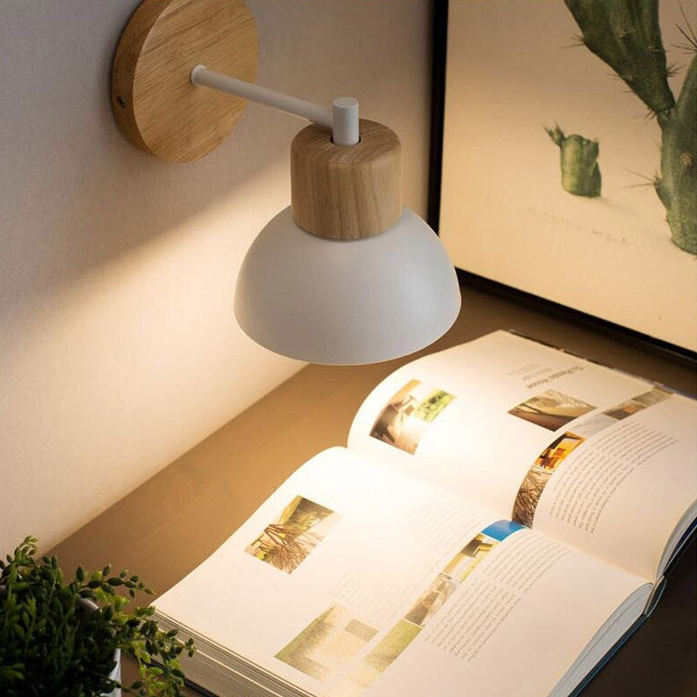 Soft retro Nordic lighting from the wall lamp creates a warm, inviting reading glow.