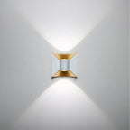 Casts dramatic X-shaped beams of gold and silver light vertically on white walls.