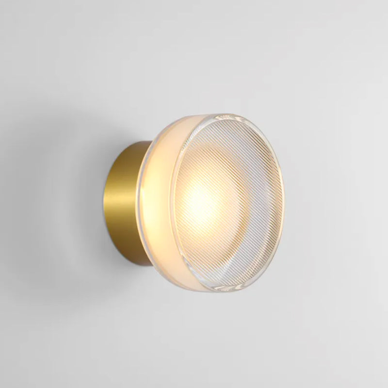 Experience elegant lighting: warm, golden glow from this stunning sconce's glass shade.