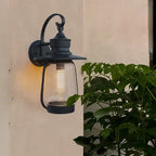 Applique murale extérieur en métal noir avec verre bullé au style vintage élégant.