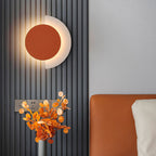 The ORLUNE HOME Circular Wall Light glows, casting a warm, modern ambiance throughout.