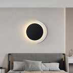 ORLUNE HOME wall light’s black circle and glowing crescent evoke a serene eclipse effect.