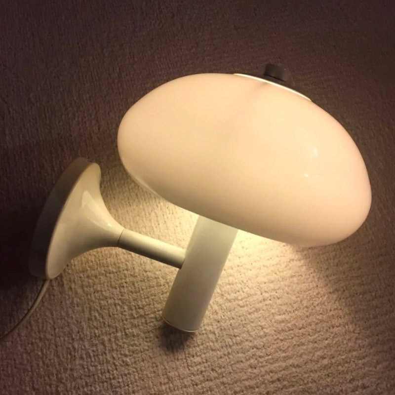Warm glow from the table lamp pairs beautifully with the Elegant Mushroom Glass Wall Light.
