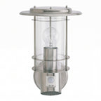 Stainless steel outdoor wall light with clear glass, visible bulb, and motion sensor at base.