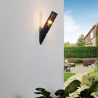 A sleek black metal outdoor wall light with motion sensor mounted on a white wall.