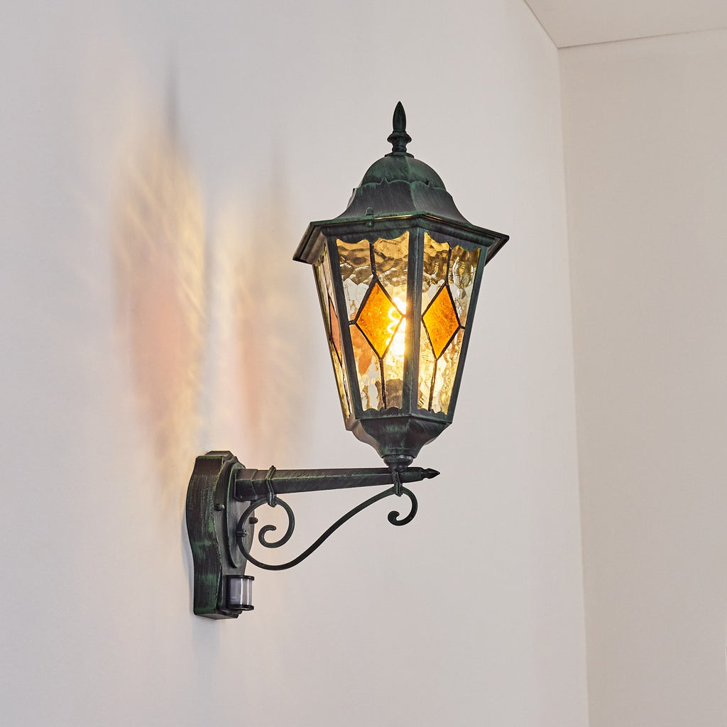 Soft light glows through stained glass panels, creating gentle patterns against the white wall.