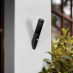 Modern black cylindrical outdoor wall light with motion sensor, showcasing sleek, minimalist design.