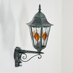 The ORLUNE wall light emits warm, vintage glow from amber diamond panels.